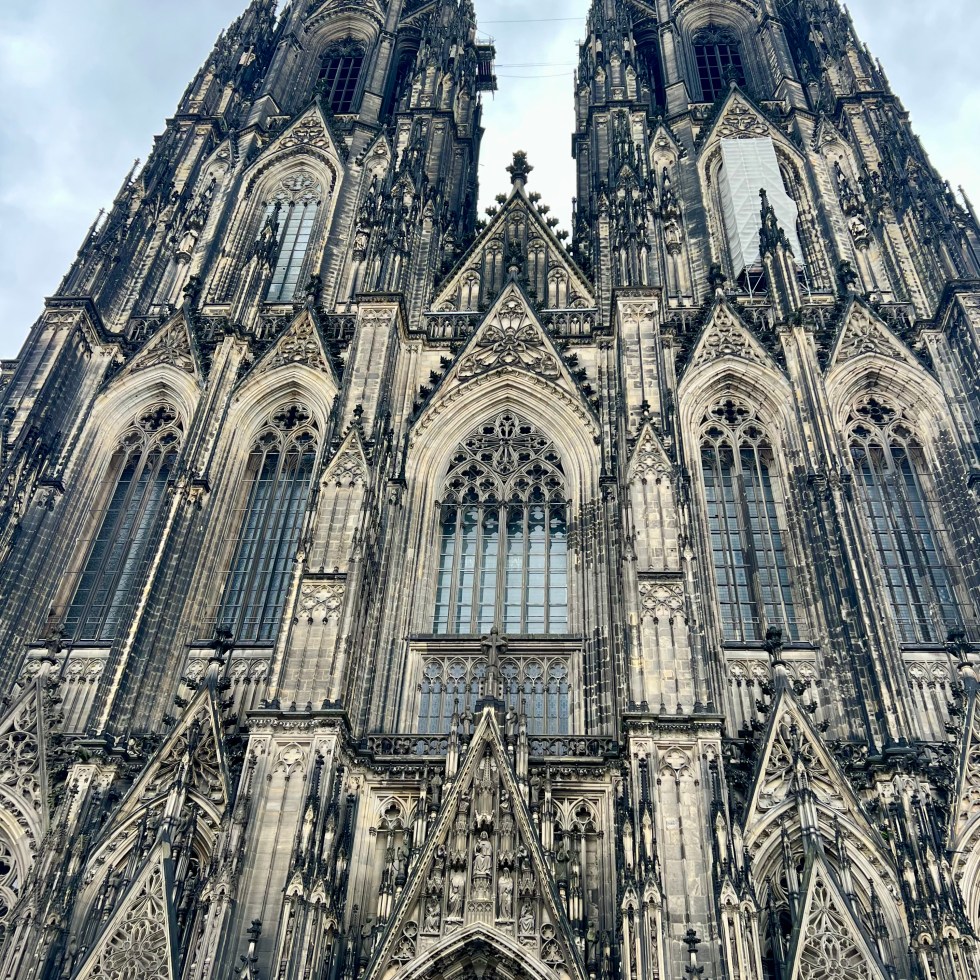 Cologne cathedral looming down with a dramatic sky